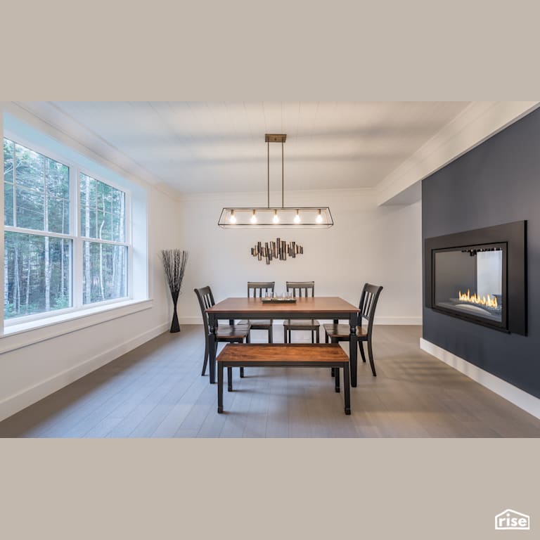 House in The Woods - Dining Room with Gas Fireplace by Homes by Highgate