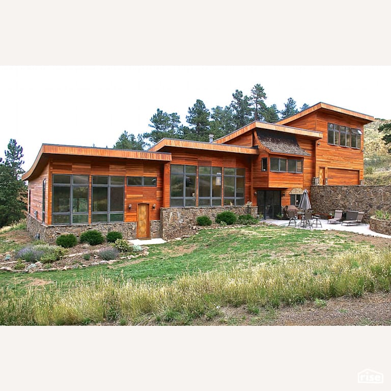 Landscaped exterior with patio with Stone Siding by Revolve Design Build