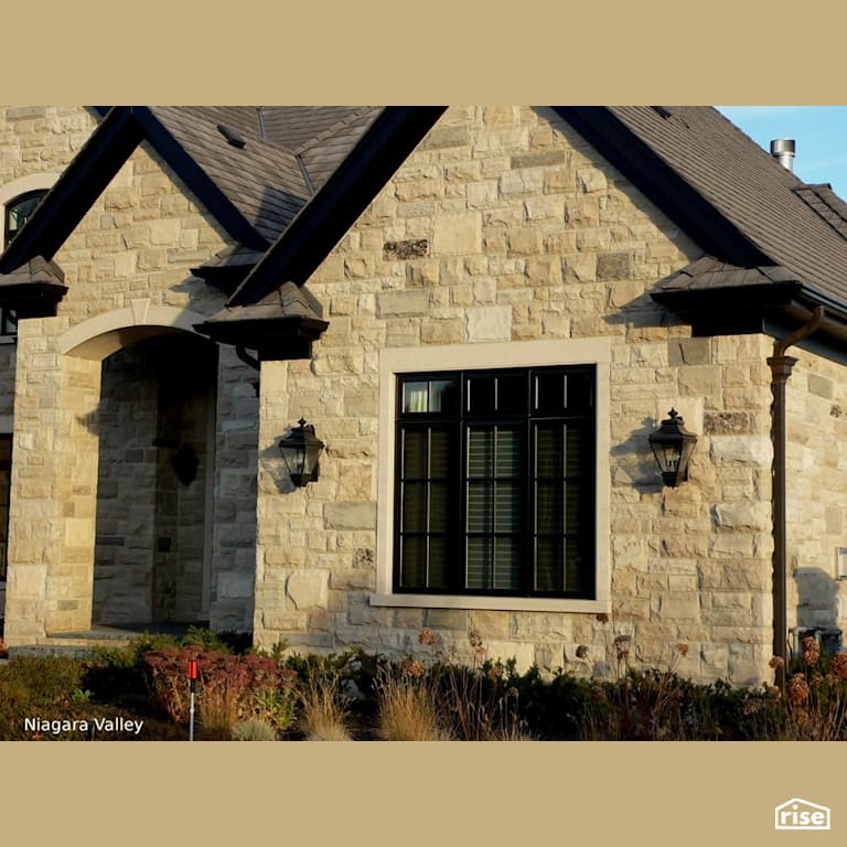 House with Stone Siding with Accent Outdoor Lighting by Masonal Stone Inc