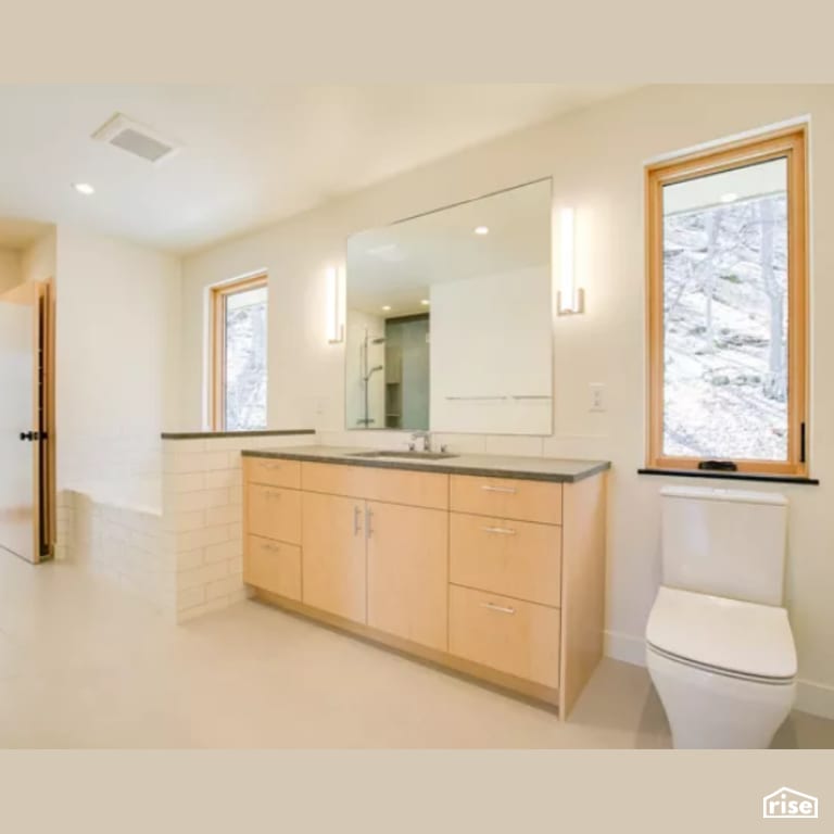 Bathroom with Low-Flow Bathroom Faucet by Constructive Builders