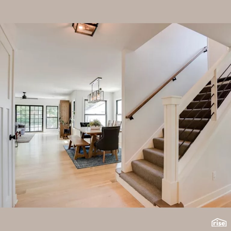 Staircase and Dining Room with Energy Star Exterior Door by Constructive Builders