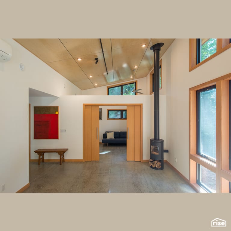 ModCab Series Living Room with Wood Stove with Concrete Flooring by FabCab Inc