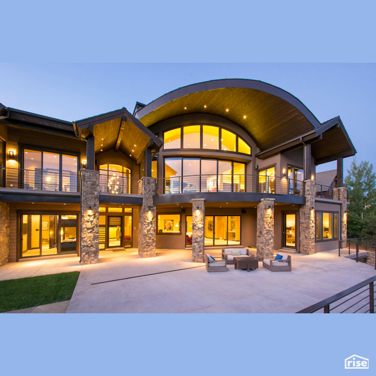 Window-lined exterior view from back patio with Stone Siding by Alpen High Performance Products
