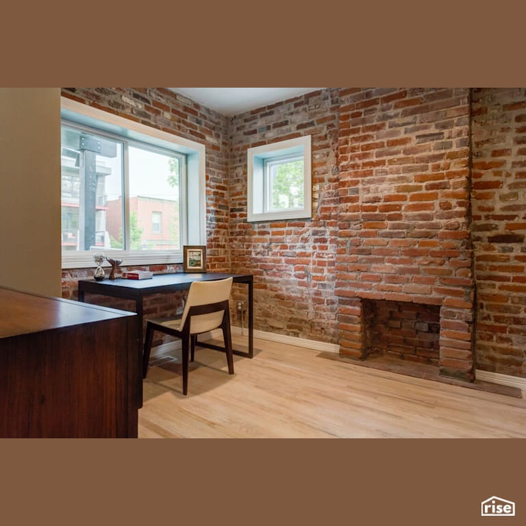 Home office with exposed brick fireplace with Fixed Window by Alpen High Performance Products
