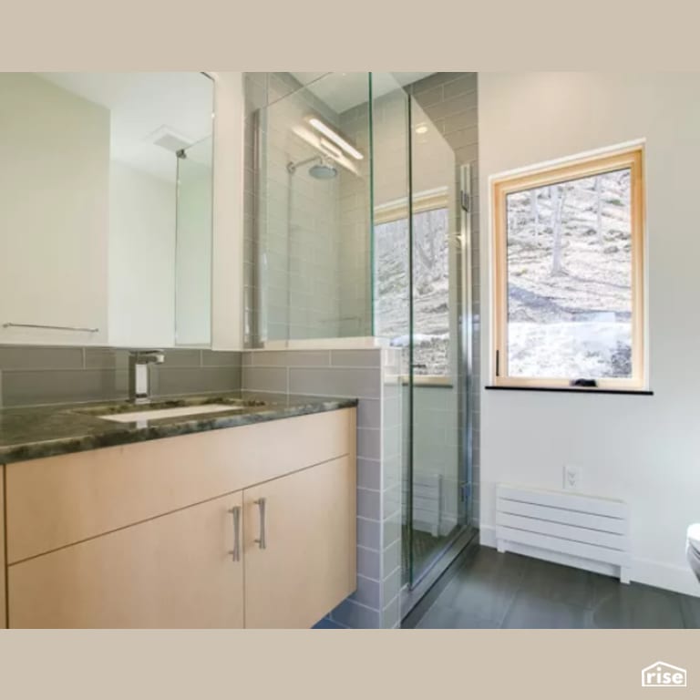 Bathroom with Low-Flow Bathroom Faucet by Constructive Builders