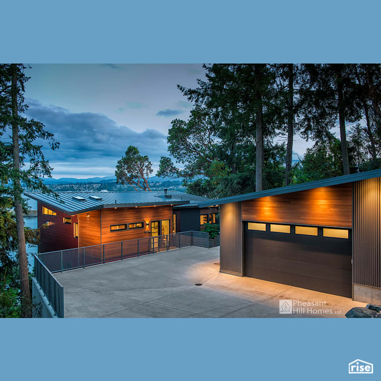Garage with Accent Outdoor Lighting by Pheasant Hill Homes Ltd.