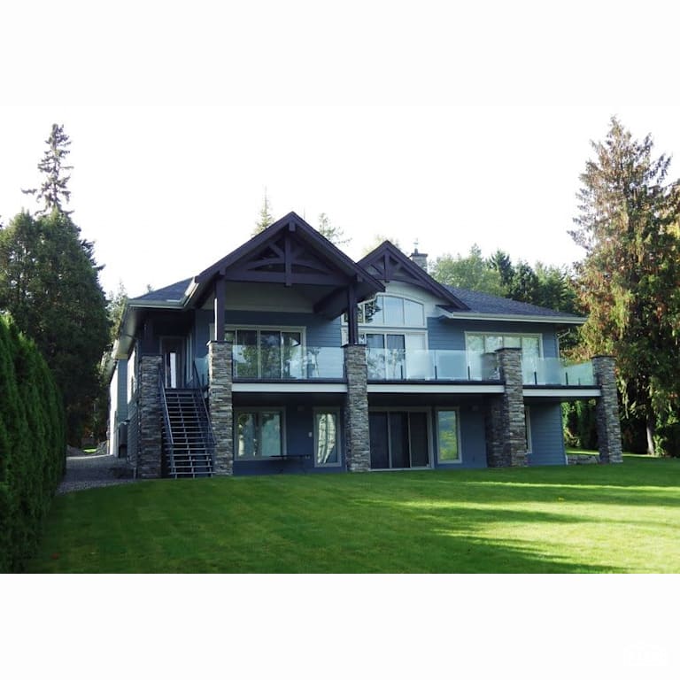 Copper Island Fine Homes - Exteriors with Stone Veneer Siding by Copper Island Fine Homes Inc.