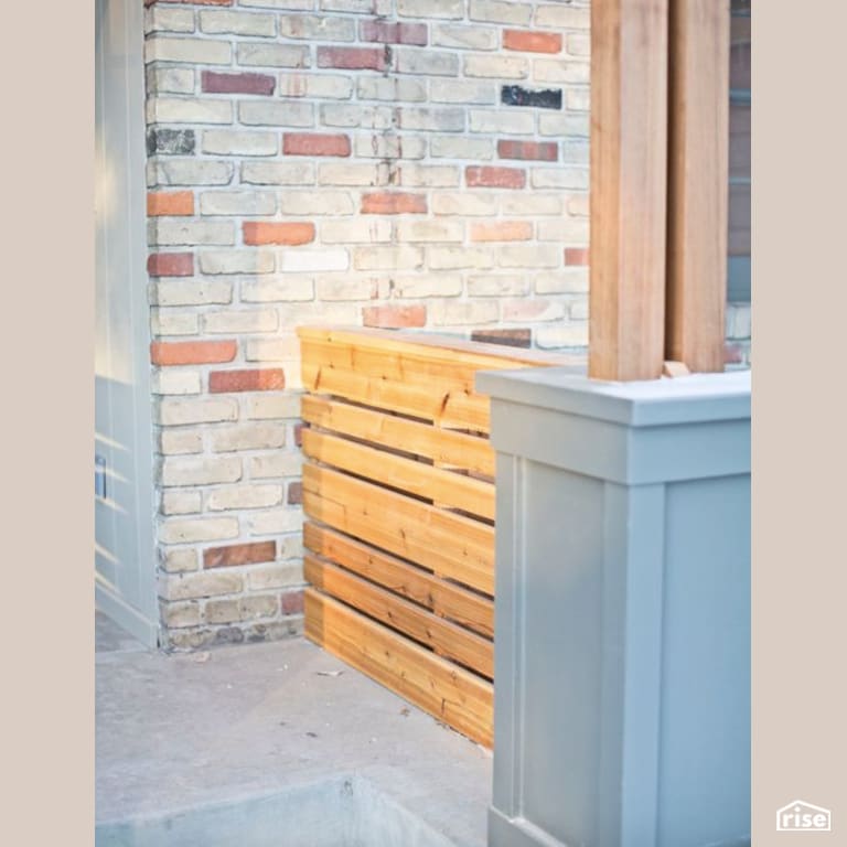 Natural Wood Accent Entryway with Stone Siding by Constructive Builders