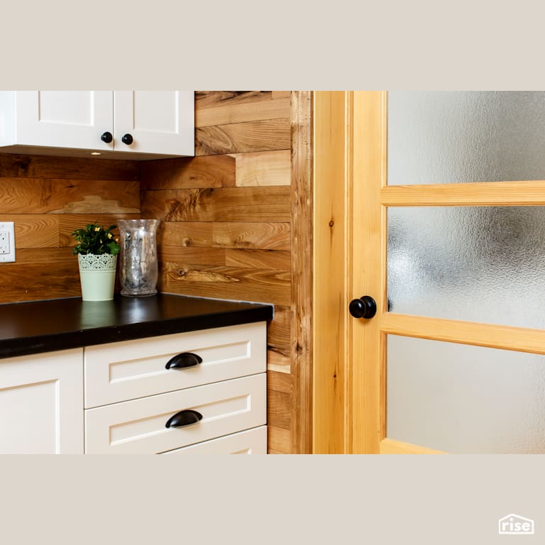 Red Castle Cabinets and Door with Reclaimed Hardwood by The Conscious Builder