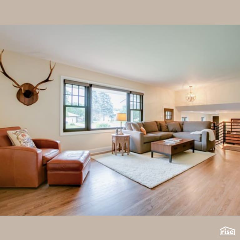 Living Room with Laminate Flooring by Constructive Builders