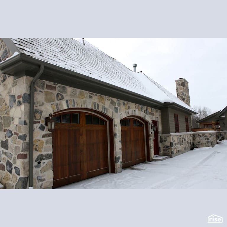 Double car garage with stone siding with Stone Siding by Masonal Stone Inc