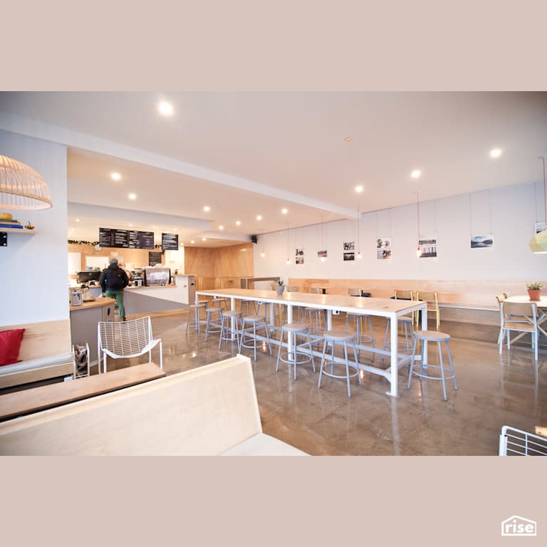 View of the cafe space with Concrete Flooring by RSI Projects