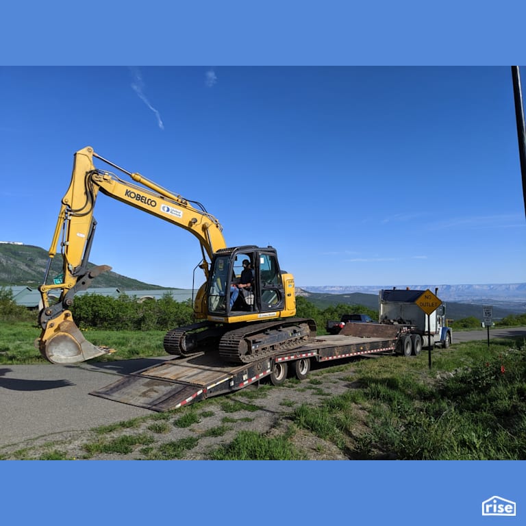 Excavator Arriving with Prefabricated Panelized Home by Phoenix Haus LLC