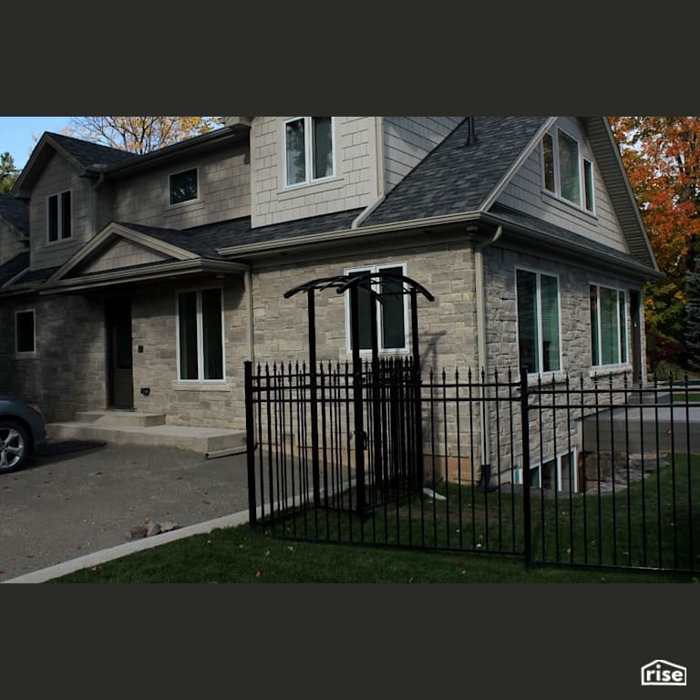 Stone home with wood shingles on second floor with Stone Siding by Masonal Stone Inc