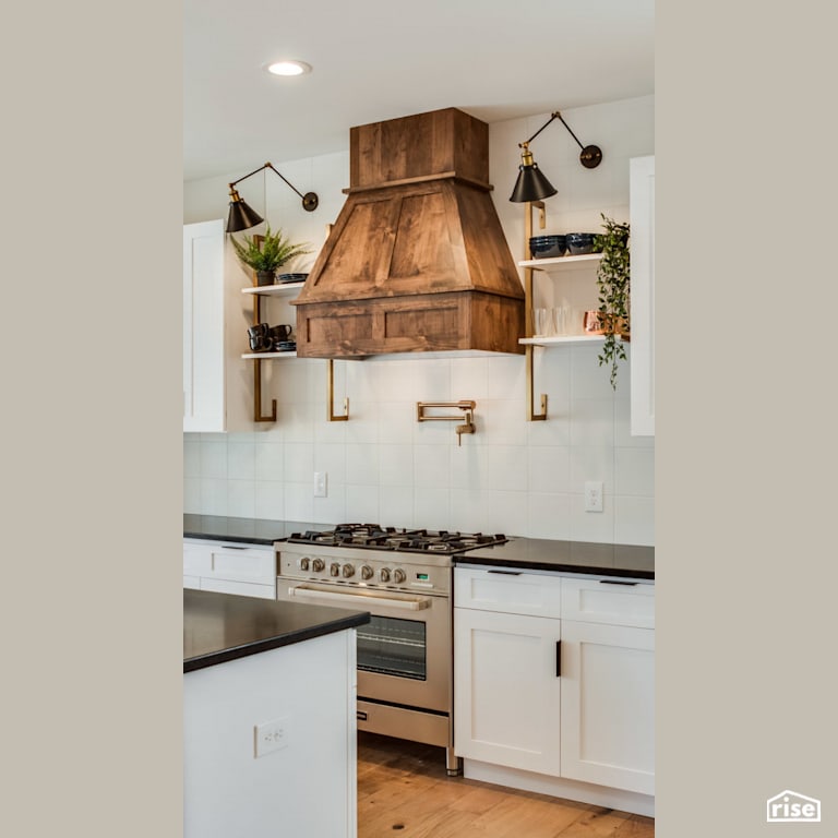 Gas range with feature wood range hood with Gas Range by Revolve Design Build