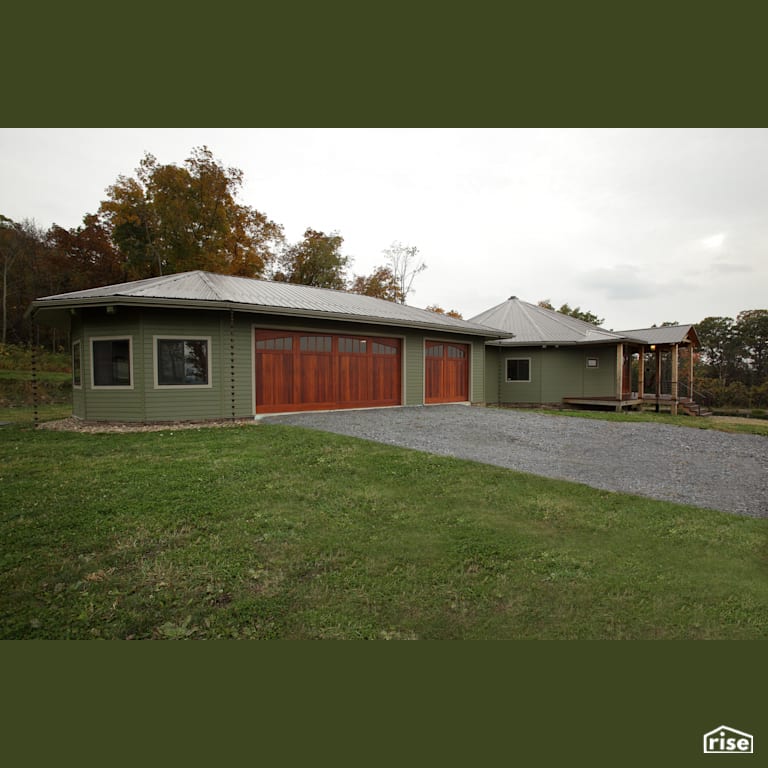 Connected roundhouse with garage with Standing Seam Metal Roof by Deltec Homes