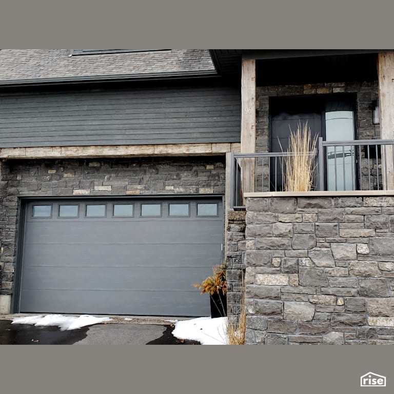 Stone sided garage with staircase to entryway with Clapboard Wood Siding by Masonal Stone Inc