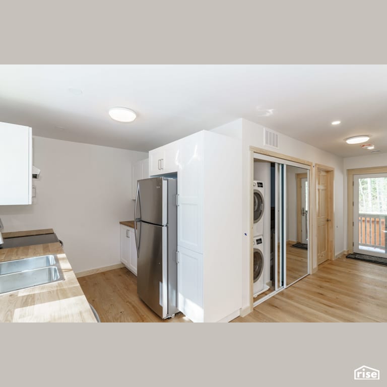 Interior_Unit2 View from Kitchen to Hallway Entrance with Clothes Washer by Tooketree Passive Homes