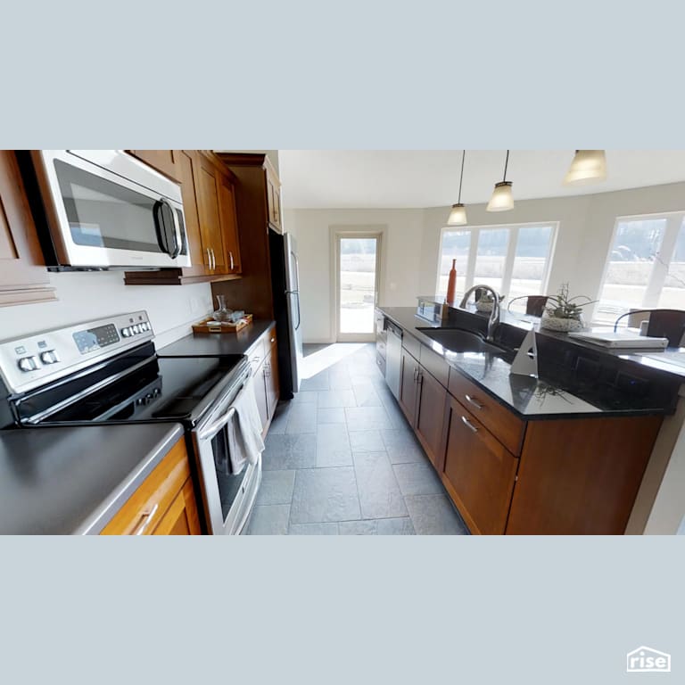 Open concept kitchen with Low-Flow Kitchen Faucet by Deltec Homes
