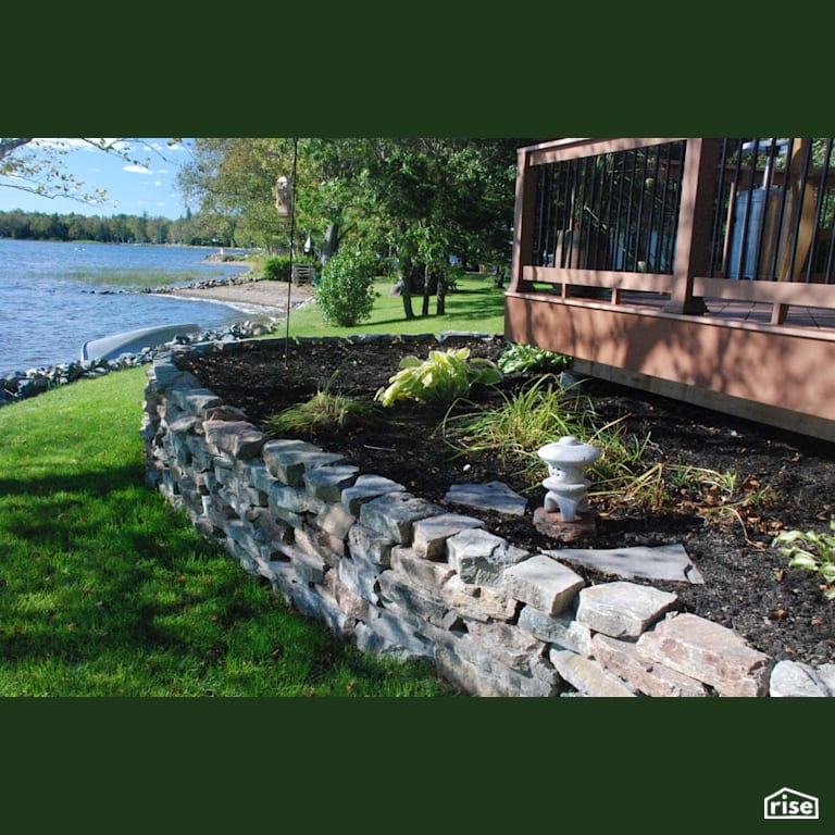 Lake Side Backyard with Natural Stones with Pressure Treated Decking by Earthworks Landscape & Design