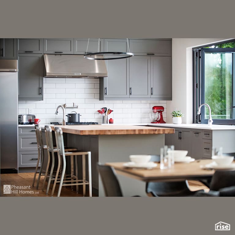 Kitchen with Salvaged Wood Countertop by Pheasant Hill Homes Ltd.