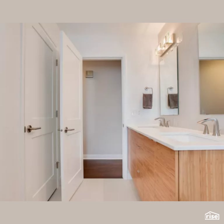 Bathroom with Wood Veneer Cabinet by Constructive Builders