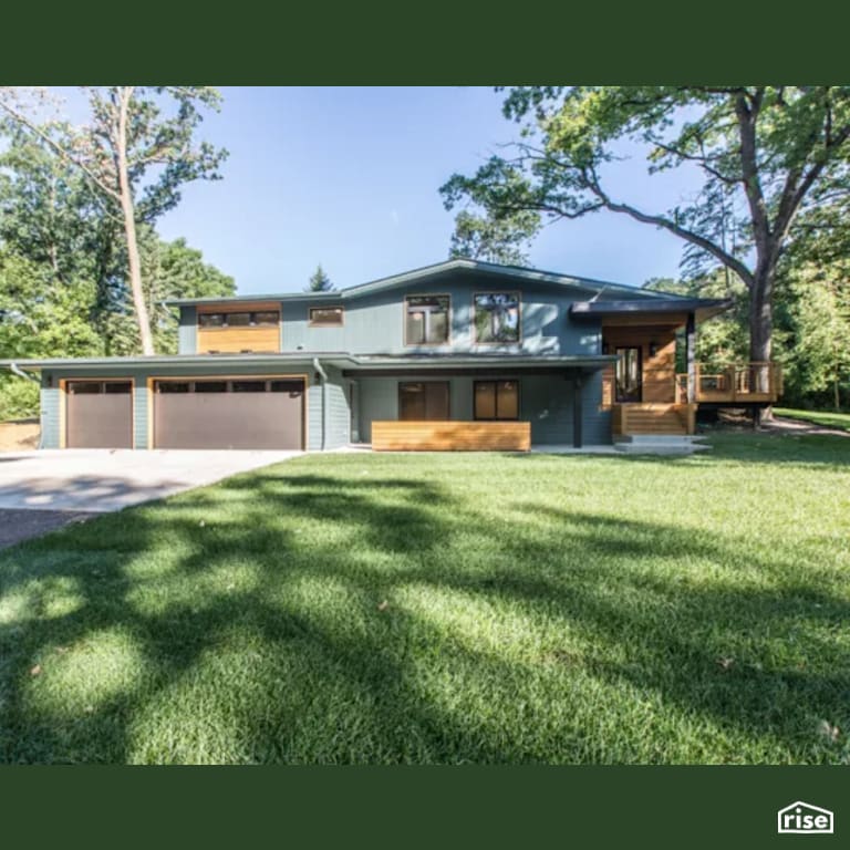 Blue House Exterior with Clapboard Wood Siding by Constructive Builders