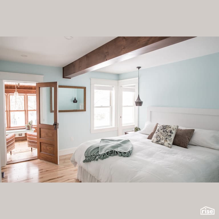 Bright bedroom with sky blue walls with Engineered Hardwood by Reimagine Designs