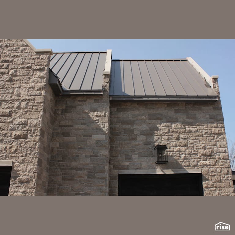 Northern Grey Blend Stone Siding with Corrugated Metal Roof by Masonal Stone Inc