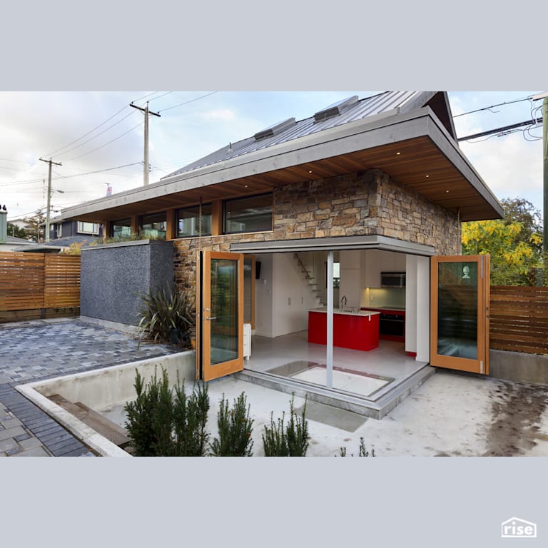 Slocan exterior patio and open doors with Concrete Flooring by Lanefab Design/Build