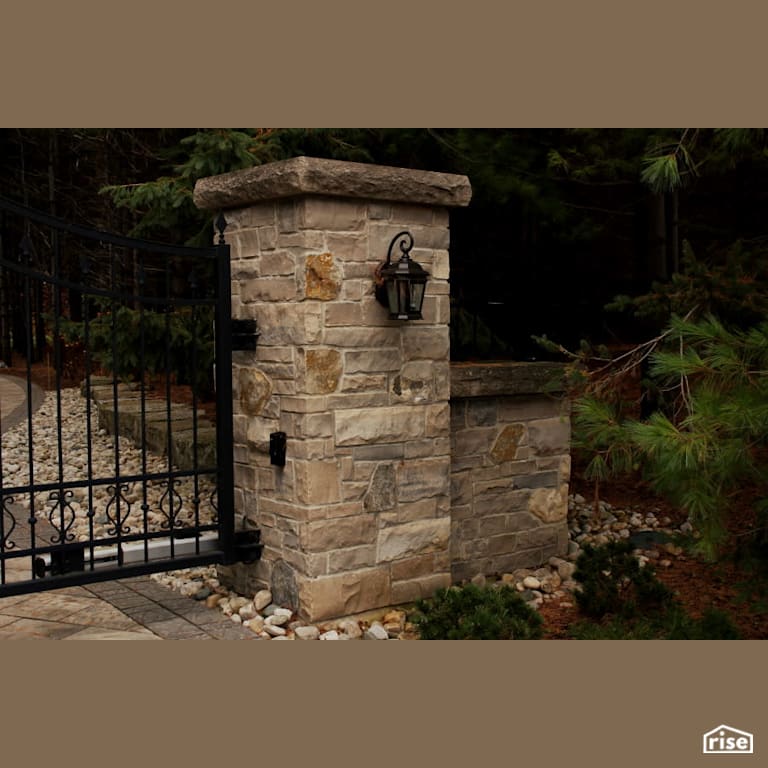 Stone gate with accent lighting with Stone Siding by Masonal Stone Inc