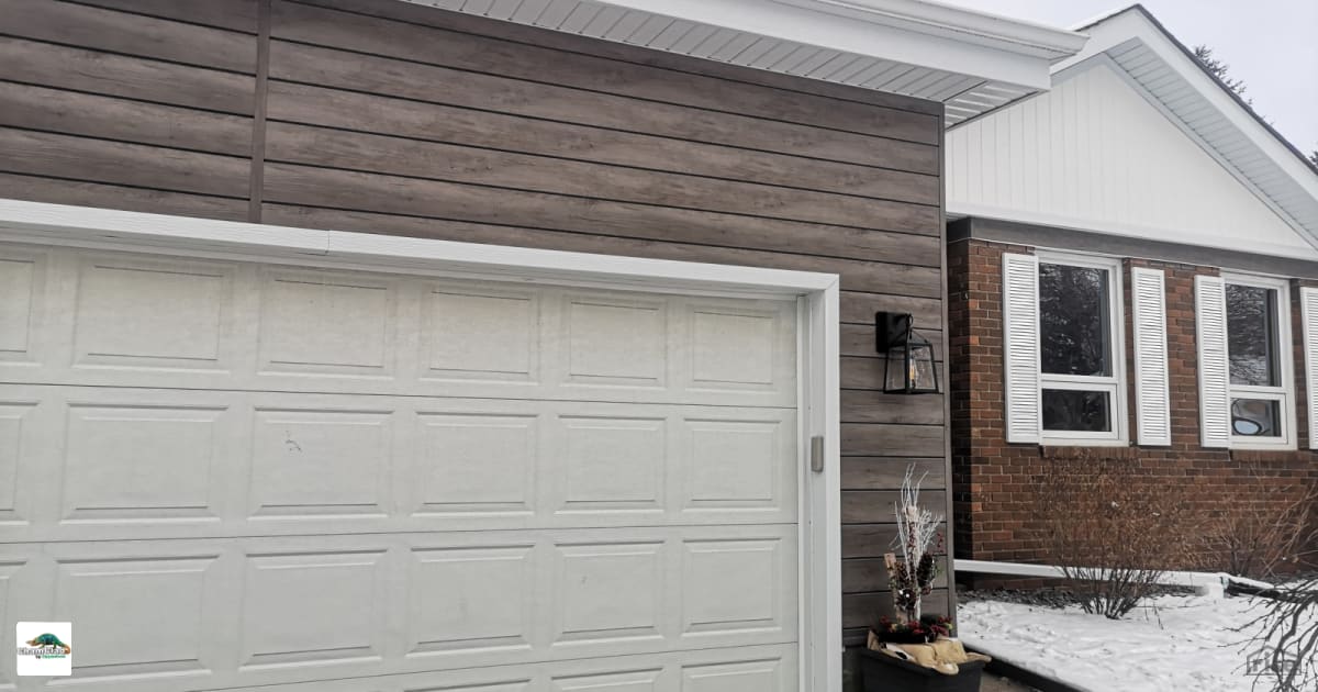 Garage with composite siding with Accent Outdoor Lighting by ChamClad ...