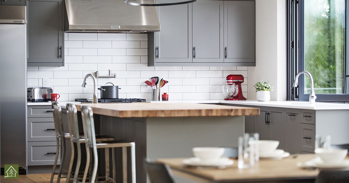 Kitchen with Salvaged Wood Countertop by Pheasant Hill Homes Ltd.