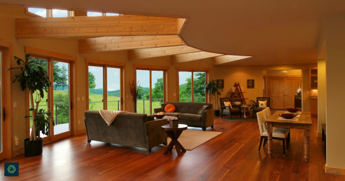 Open living and dining room with Fixed Window by Deltec Homes