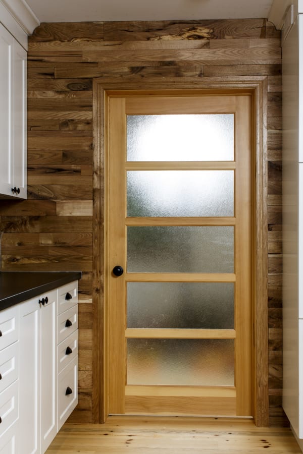 Conscious builder feature wall with glass door