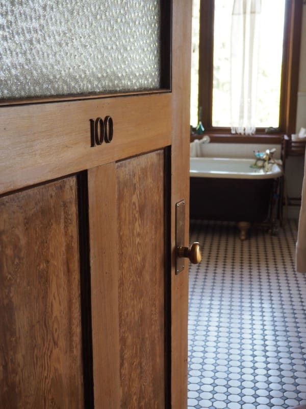 Reclaimed door and salvaged bathtub