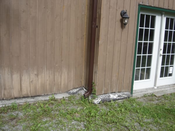 No downspout extender causes damage against home