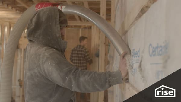 installing insulation in a double studded wall