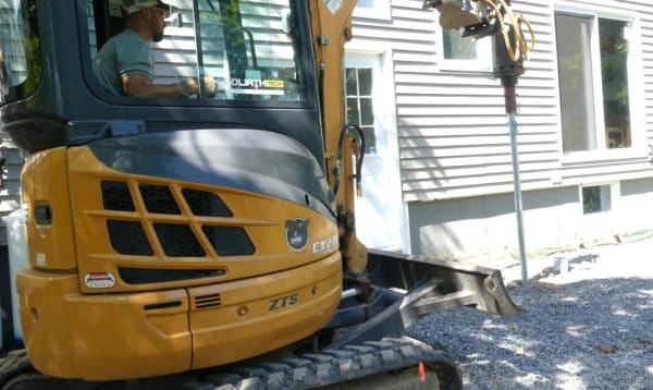 Installing helical piers for a deck