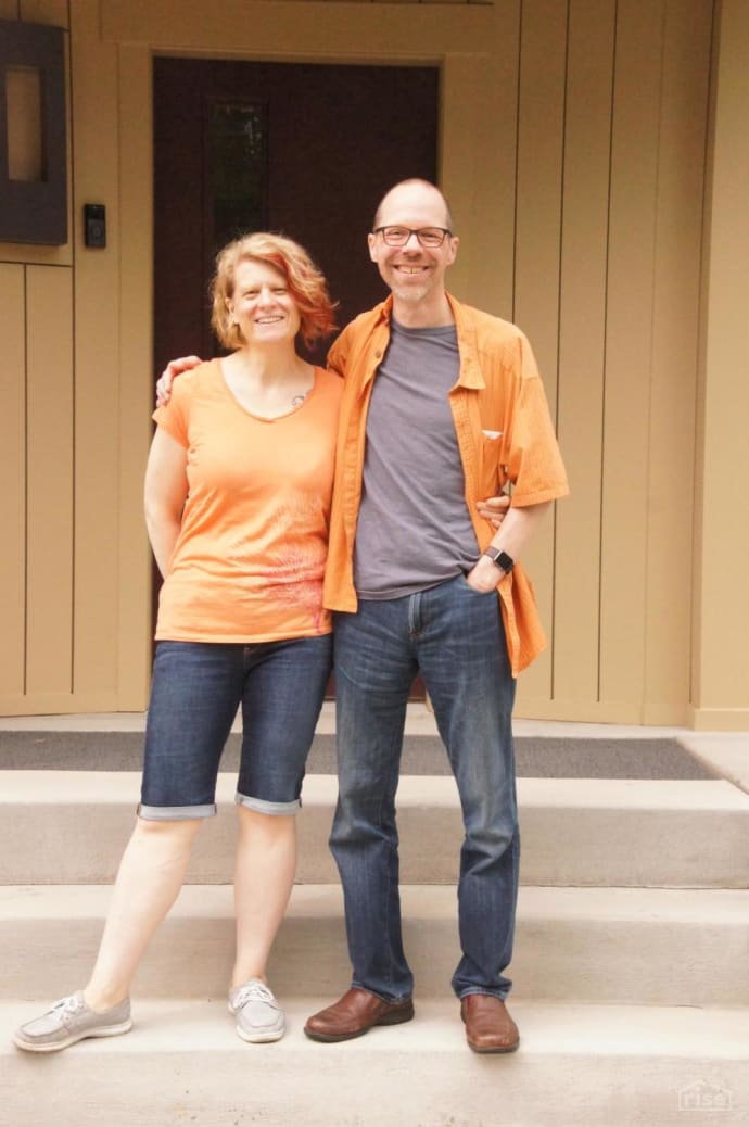 mark and kate hanson in front of their home