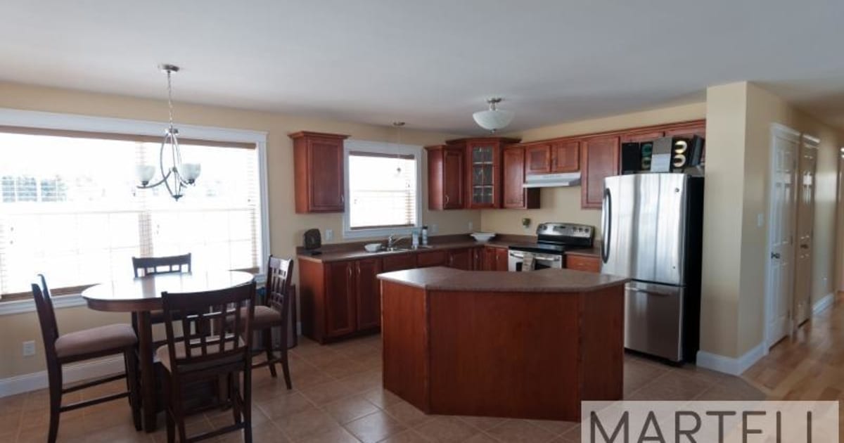 Rise Netzero Home Kitchen with Refrigerator by Martell Homes